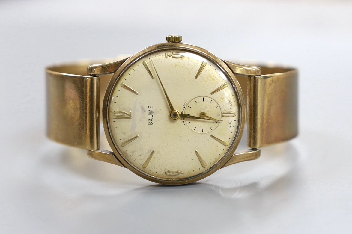 A gentleman's yellow metal Baume manual wind wrist watch, on a bracelet strap, gross weight 44.3 grams.
